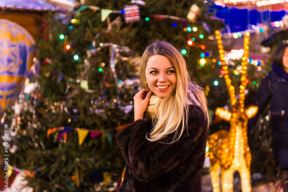 Portrait in full growth, Russian beautiful woman in a mink coat on the Red Square in Moscow in Christmas time