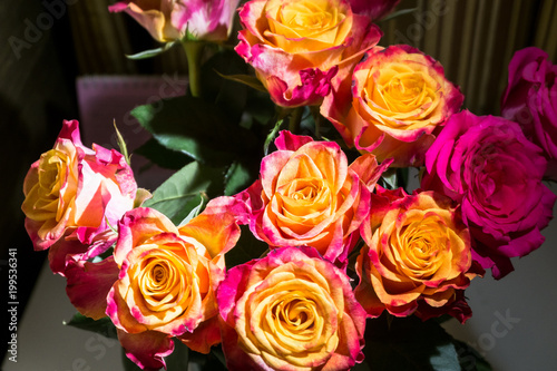 Festive bouquet of fresh roses with original yellow and crimson coloration.