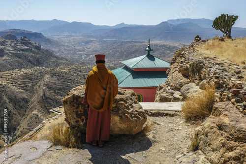 Priest looking over scarp at monastery Debre Damo, near Adigrat in Tigray Region, Ethiopia.