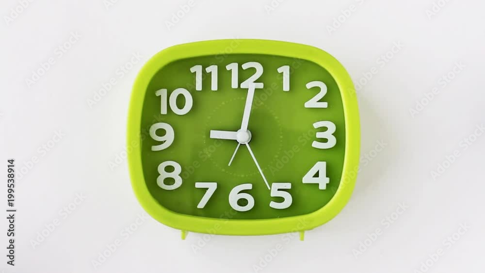 Green clock with white numbers and arrows on white background, Time Lapse Green clock with white numbers and arrows on white background, Time Lapse