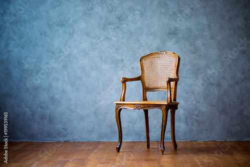 old chair on a gray wall background.