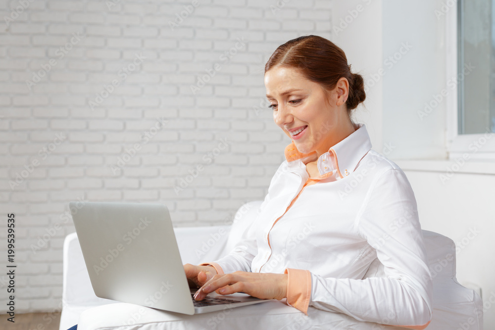 Young woman working at laptop in the office Young woman working at laptop in the office