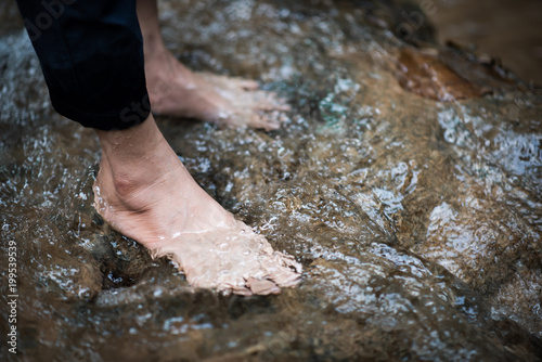 Feet being cooled down by river water