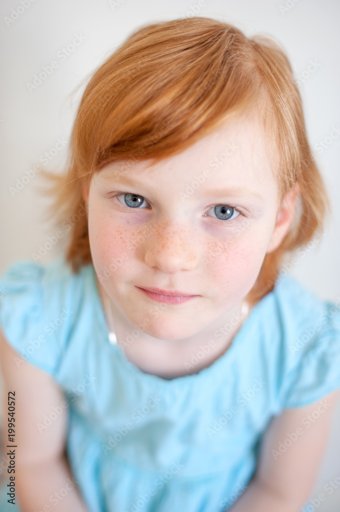 Cute red-haired girl in a blue dress Cute red-haired girl in a blue dress