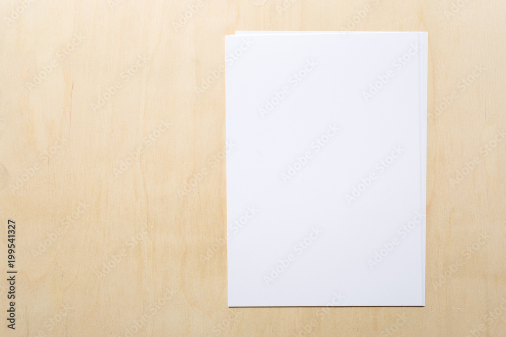 White business card on wooden table. Blank portrait A4. White business card on wooden table. Blank portrait A4.