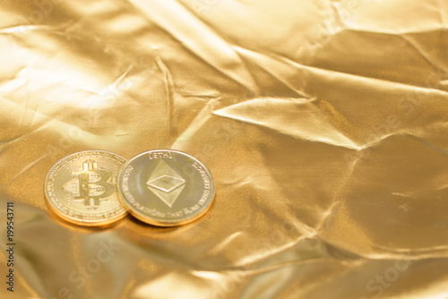 bitcoin and ethereum on gold background