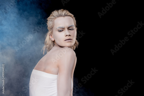fashionable girl with white makeup, isolated on black with smoke