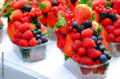 Basket with fresh strawberry  blackberries  blueberries  raspberries and red currant.