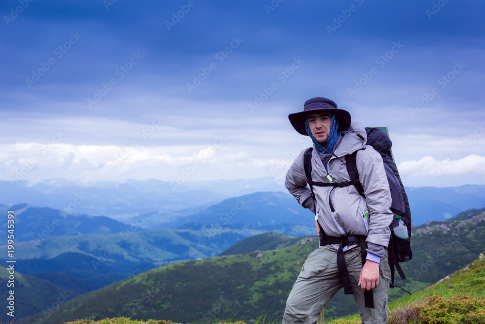 tourist with bag on the background majestic mountains