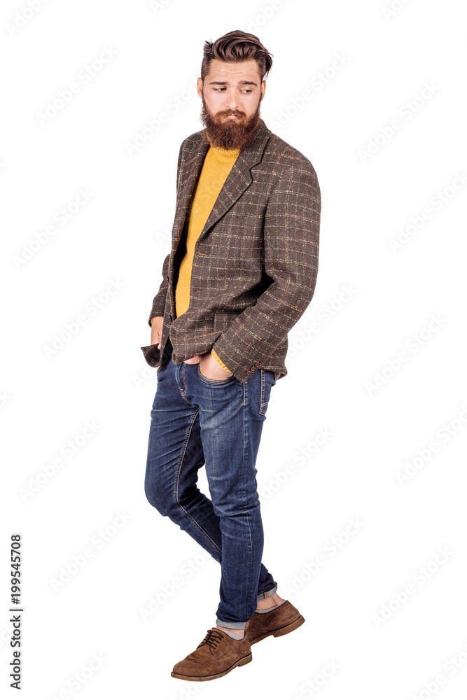 Naklejka premium Handsome young man with beard full height standing against white background.