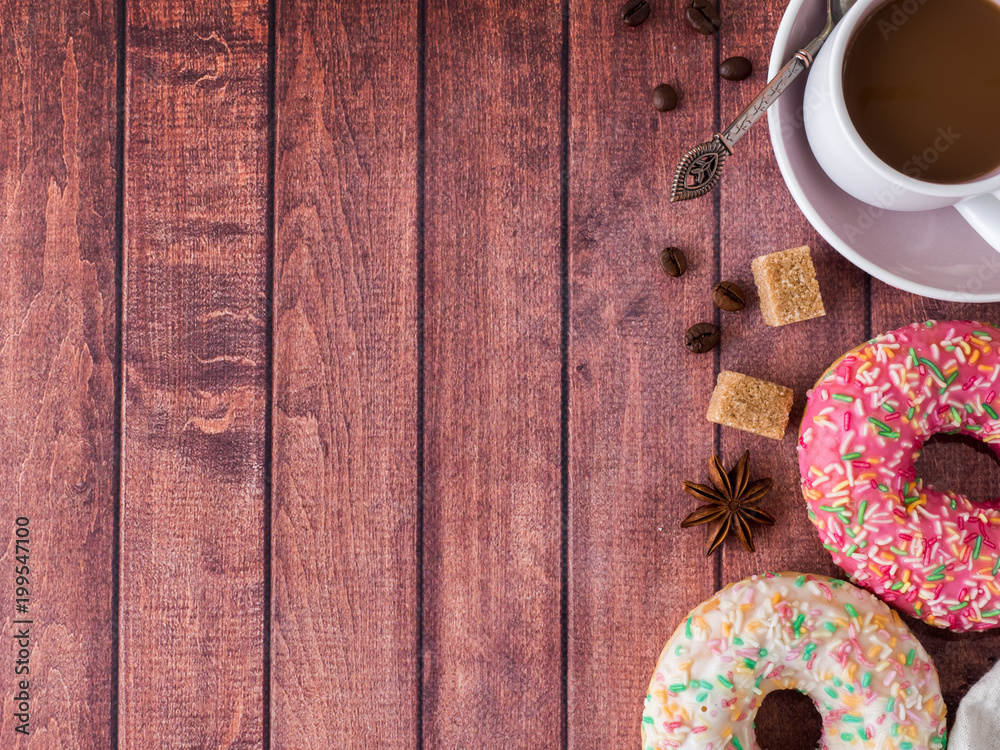 Donuts and coffee on wooden table. Top view with copy space Donuts and coffee on wooden table. Top view with copy space