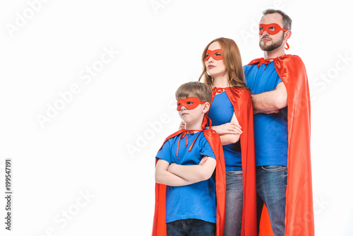 super family in masks and cloaks standing with crossed arms and looking away isolated on white