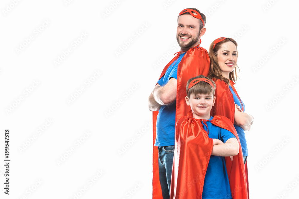super family in masks and cloaks standing with crossed arms and smiling at camera isolated on white