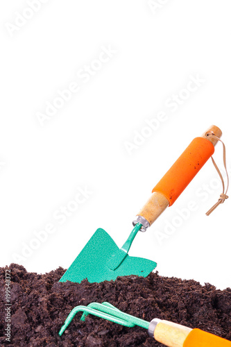 Gardening tool in soil isolated on white.