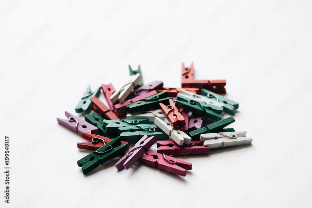 Pile of scattered clothes pegs isolated on white background Pile of scattered clothes pegs isolated on white background