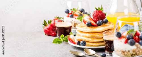Fotografering Breakfast composition with fresh pancakes and berries on light gray concrete background