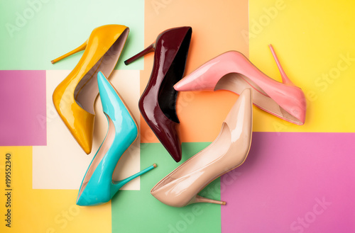 Set of colored women's shoes on a colored background