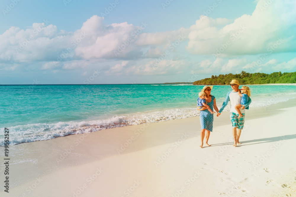 happy family with two kids walking on beach