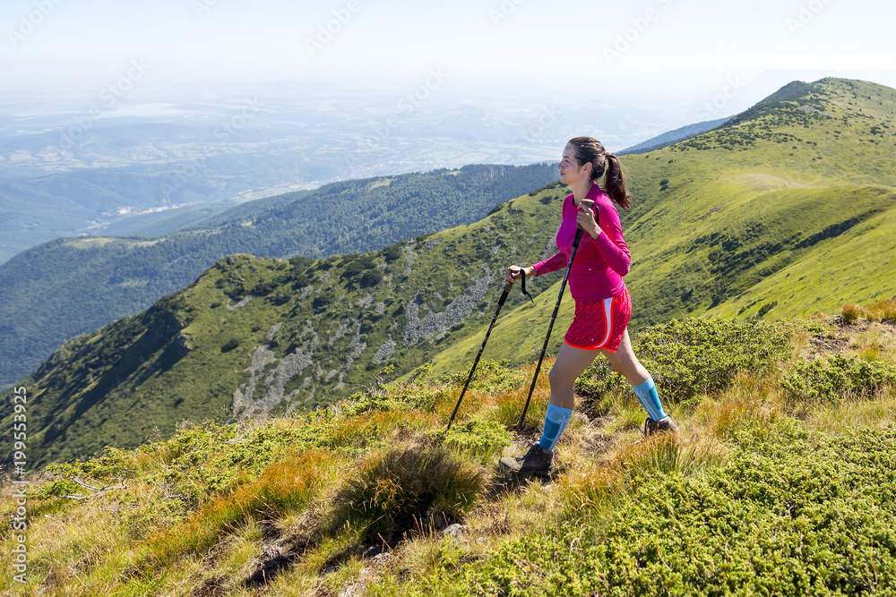 Young woman in pink trekking in the mountain