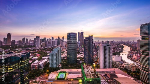 Manila, Philippines, Day to Night Time Lapse View Showing Makati City and Pasig River at Sunset photo
