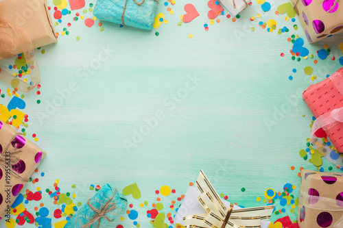 A frame of gifts and confetti with a blank space in the center for an inscription or congratulations. View from above
