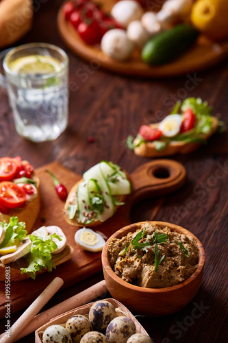 Paste from chicken liver with vegetable sandwiches and quail eggs, shallow depth of field, close-up.