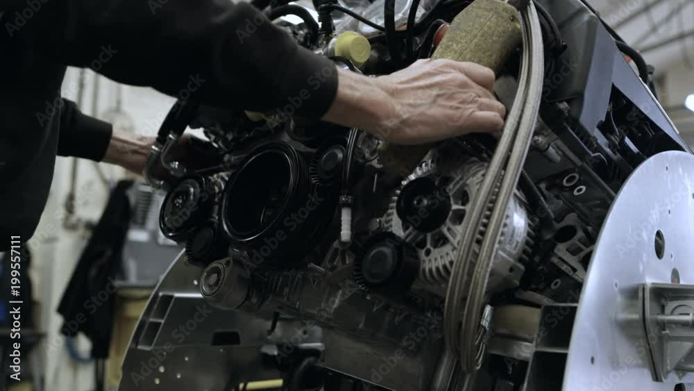 Automobile sports car manufacturing plant engineers working on vehicles Automobile sports car manufacturing plant engineers working on vehicles