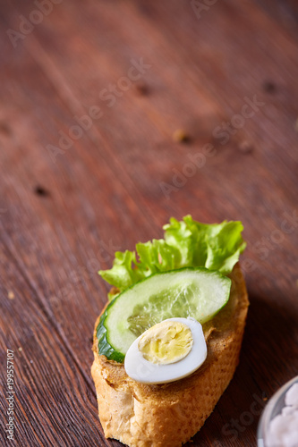 Breakfast sandwich with homemade paste, vegetables and fresh greens, shallow depth of field photo