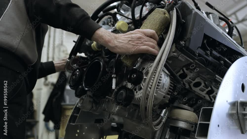 Automobile sports car manufacturing plant engineers working on vehicles Automobile sports car manufacturing plant engineers working on vehicles
