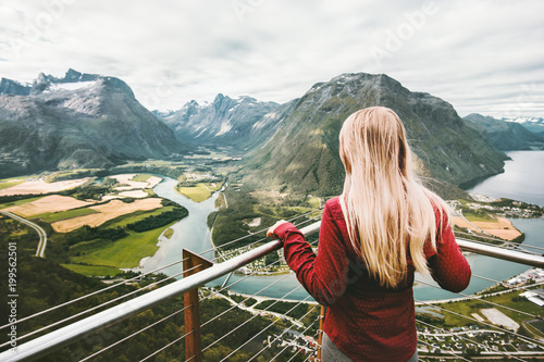 Blonde woman enjoying mountains landscape Travel Lifestyle adventure vacations success emotions in Norway girl standing alone on Rampestreken viewpoint photo