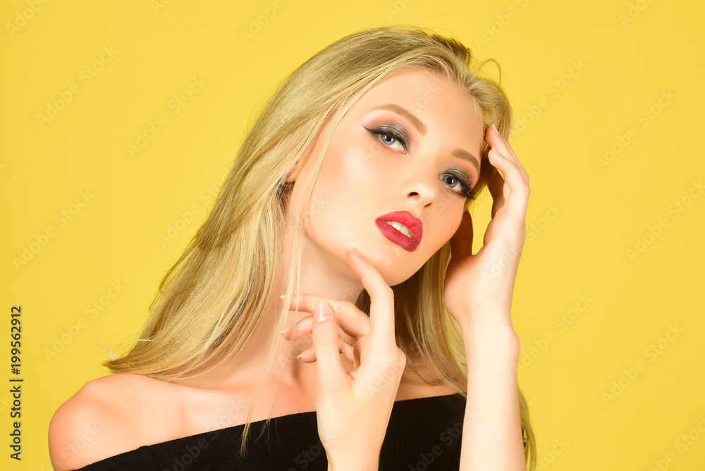 Fashion, health, beauty and spa concept - charming woman with red lips, perfect skin and blonde hair. Beautiful girl with great makeup, natural manicure - isolated on yellow background. Fashion, health, beauty and spa concept - charming woman with red lips, perfect skin and blonde hair. Beautiful girl with great makeup, natural manicure - isolated on yellow background.