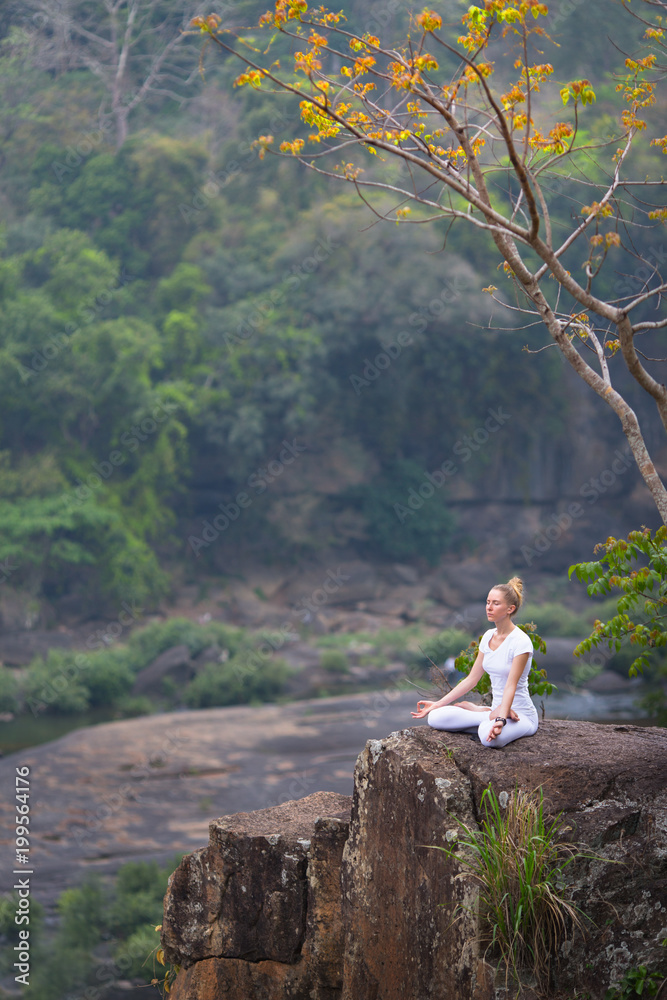 Serenity and yoga practice with woman at the cliff
