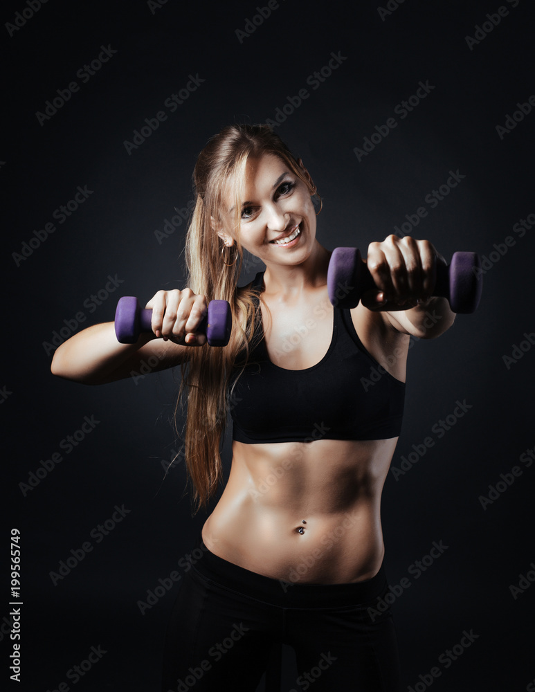 Sporty girl doing studio shot over black background Sporty girl doing studio shot over black background