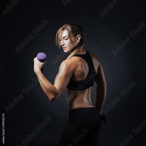 Sporty girl doing studio shot over black background