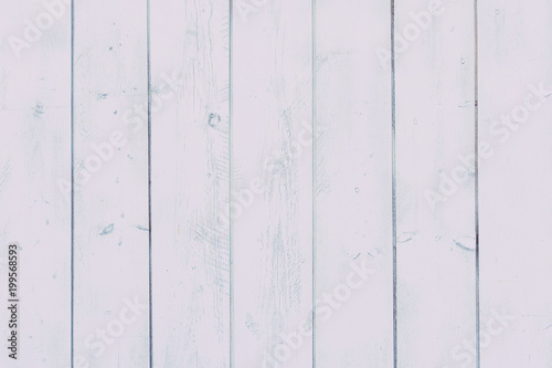Vertical planks painted white paint.