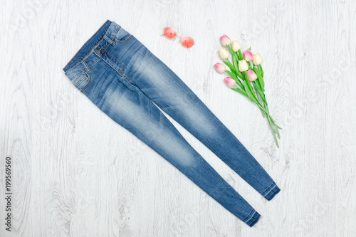 Blue jeans and bouquet of tulips. Fashionable concept © somemeans