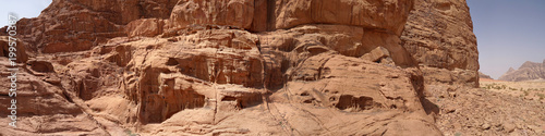 Composite panorama of high resolution aerial photos of a monolithic mountain in the central area of the desert reserve of Wadi Rum, Jordan, made from near distance