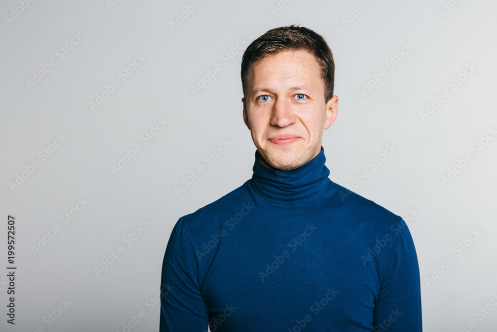 Casual guy with a warm smile over white grey background. Casual guy with a warm smile over white grey background.