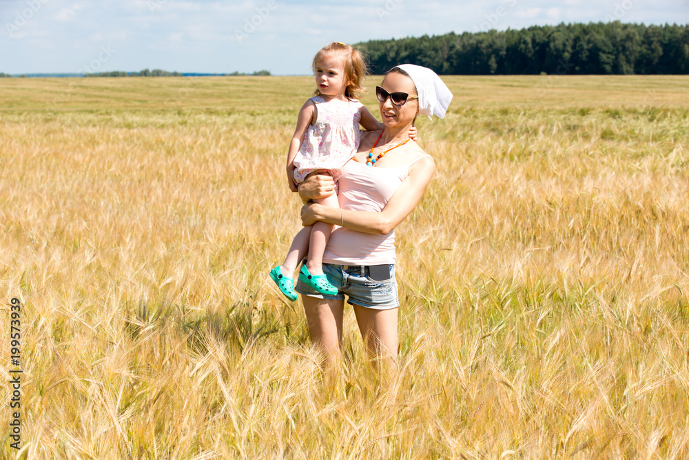 Mom and daughter in a cereal field Mom and daughter in a cereal field
