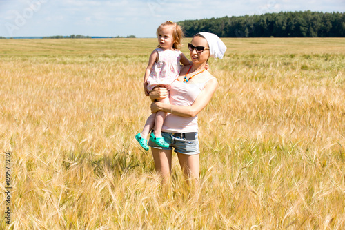 Mom and daughter in a cereal field
