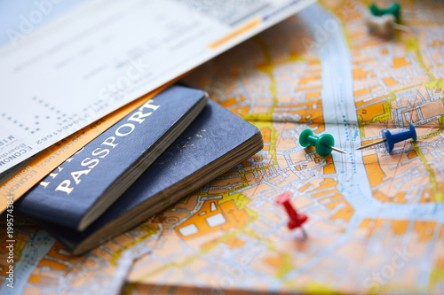 pins marking travel itinerary points on map and passport photo