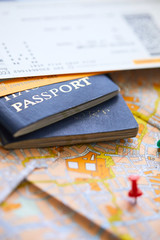 pins marking travel itinerary points on map and passport