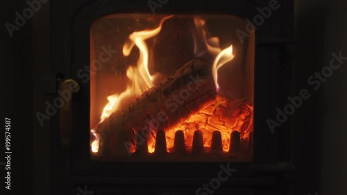 A slow-motion close up of a log burning multi-fuel stove. photo