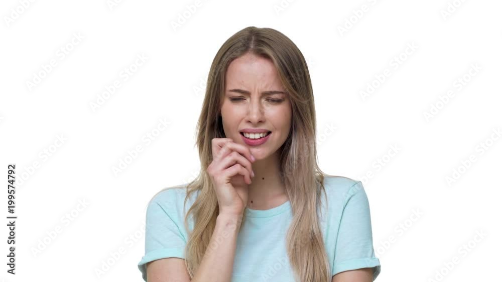 Portrait of beautiful woman 20s wearing basic t-shirt biting her lips and expressing hesitation, isolated over white background in studio. Concept of emotions Portrait of beautiful woman 20s wearing basic t-shirt biting her lips and expressing hesitation, isolated over white background in studio. Concept of emotions