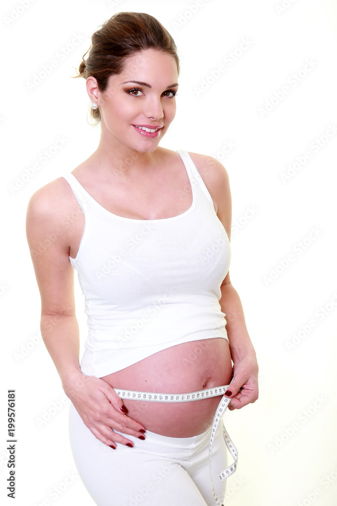 Young and pretty woman measuring belly lap Young and pretty woman measuring belly lap