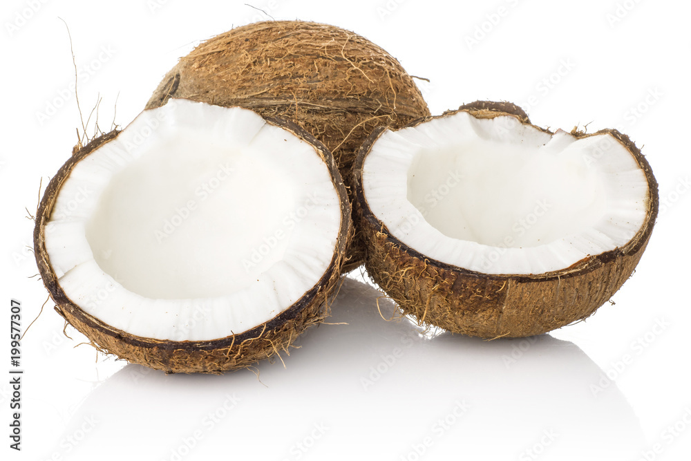 Coconut and one cracked in two halves isolated on white background brown fibrous shell with milk meat. Coconut and one cracked in two halves isolated on white background brown fibrous shell with milk meat.