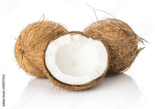 Two coconuts with one half isolated on white background brown fibrous shell with milk meat.