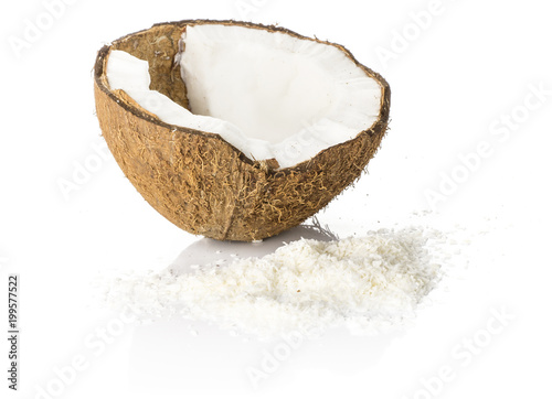 One coconut half with shavings isolated on white background brown fibrous shell with milk meat.