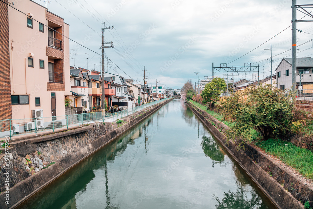 Residential buildings and river at spring day in Kyoto, Japan