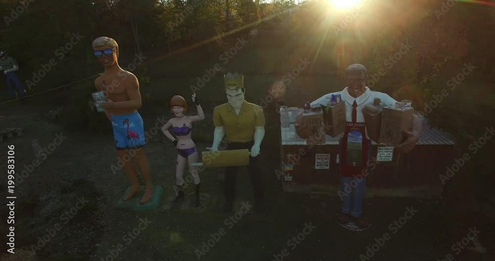 Backlit sunrise aerial views of an eccentric’s collection of giant American roadside attractions and oddities like Muffler Man, Brian Wilson the Beach Boy, Muffler Woman, and Grocery Man.  All set in 